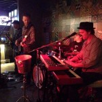 A band playing at the Flying Iguana with a backdrop of patchwork cement tile from Villa Lagoon Tile.